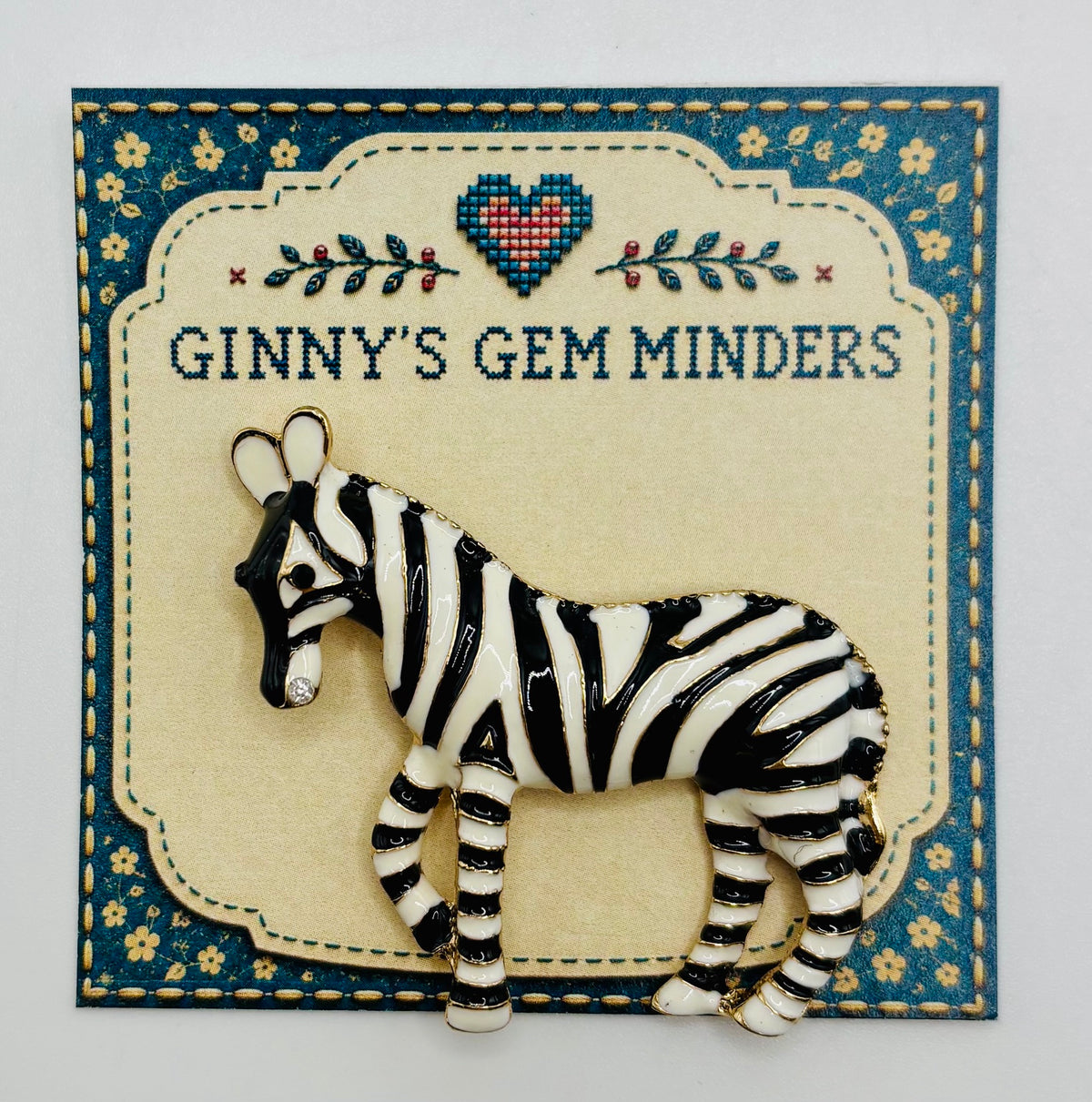 Enamel zebra needle minder on display card