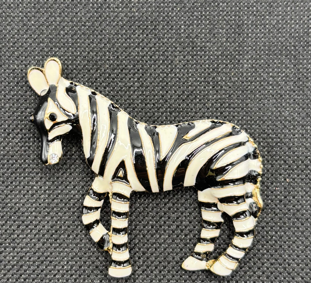 Enamel zebra needle minder on dark fabric