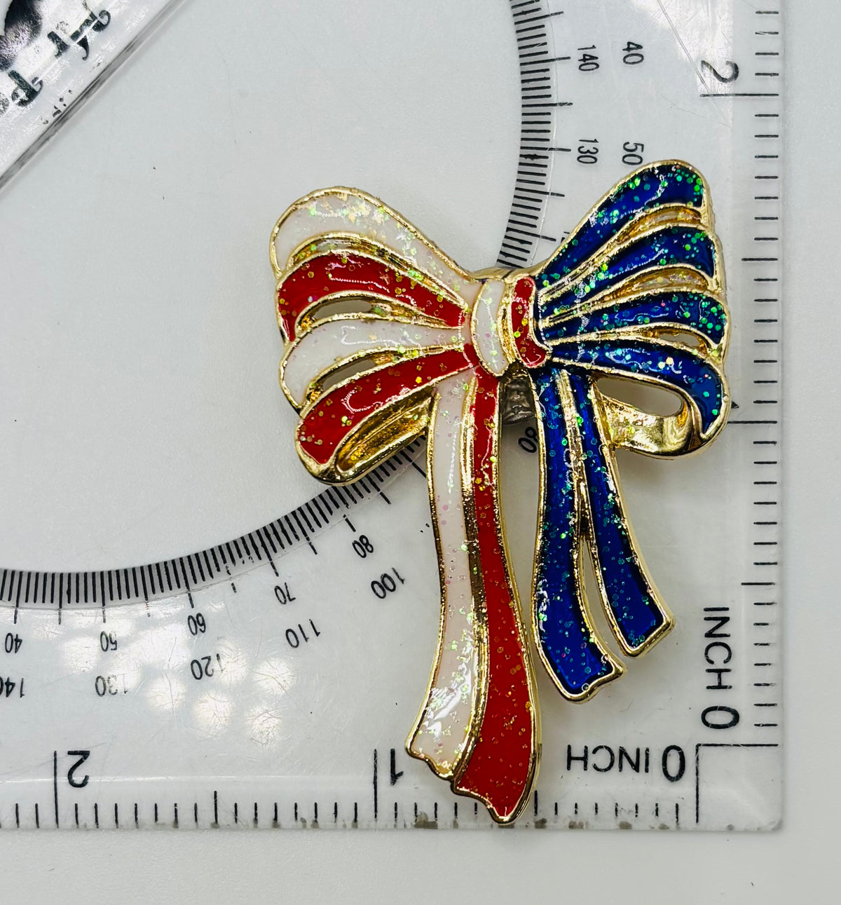 Glittery Red, White, Blue Enamel Bow Needle Minder — ruler