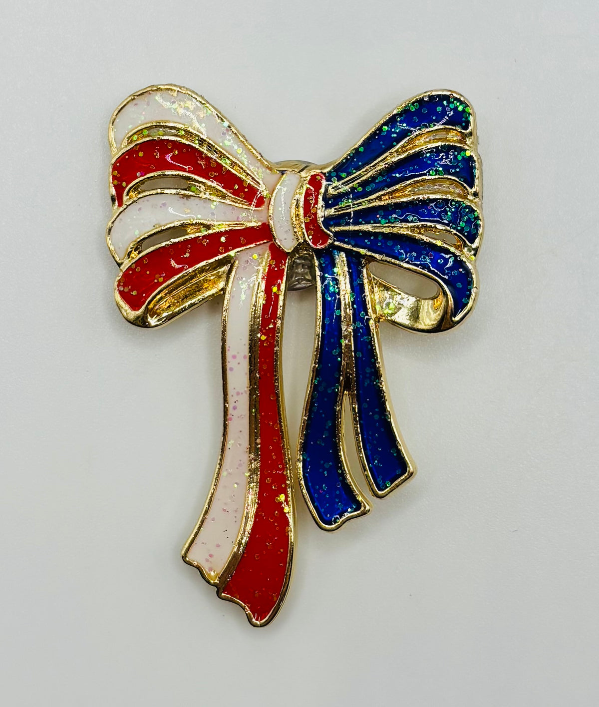 Glittery Red, White, Blue Enamel Bow Needle Minder — white background