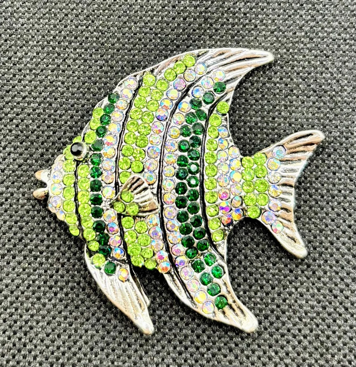 Green crystal angelfish needle minder on dark fabric