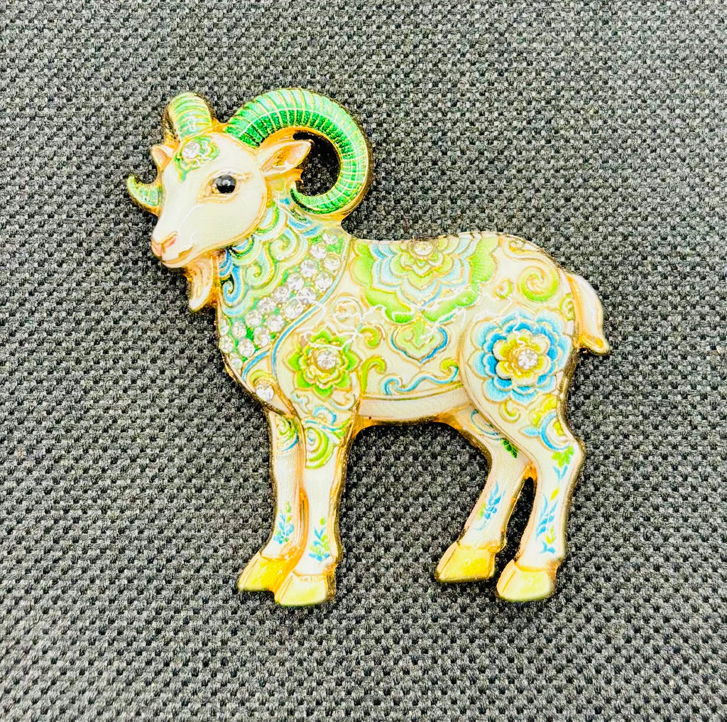 Green floral goat needle minder on dark fabric