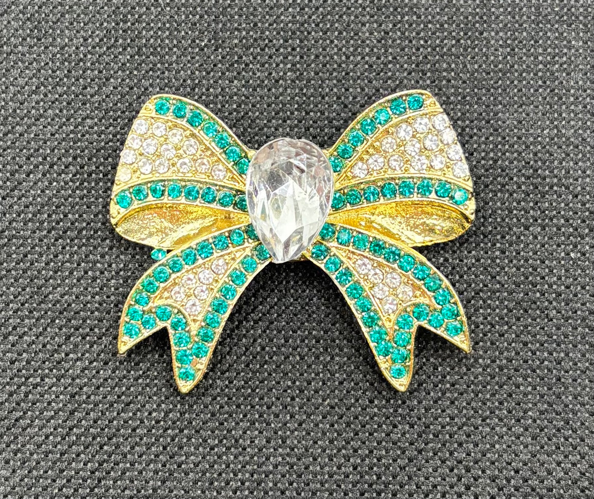 Beautiful Green and Gold Crystal Bow Needle Minder — dark fabric