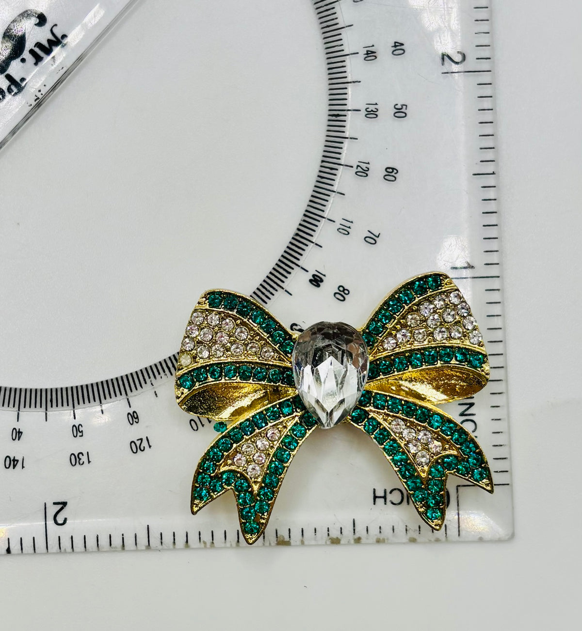 Beautiful Green and Gold Crystal Bow Needle Minder — ruler