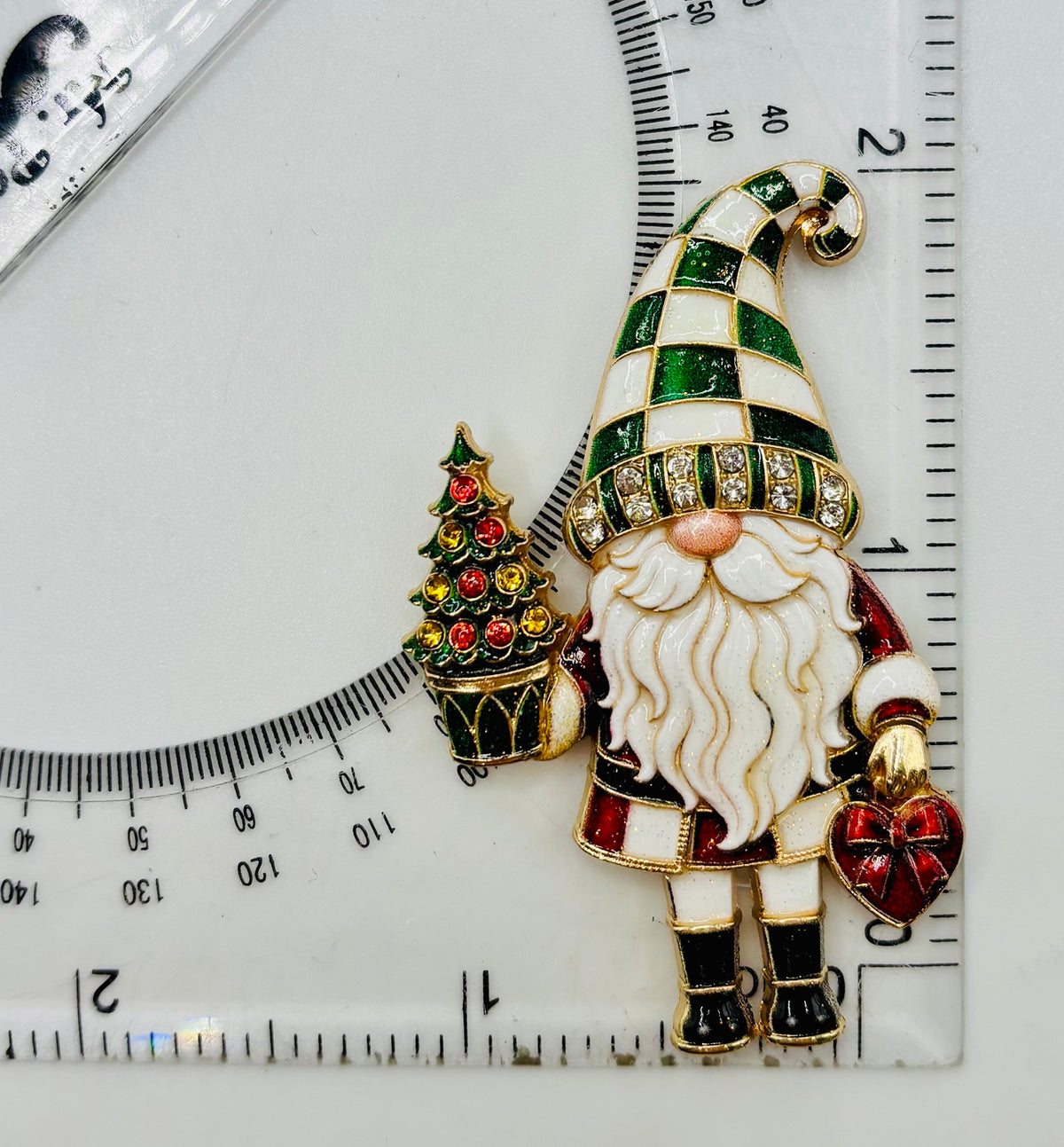 Lovely Green Hat Gnome Needle Minder beside a ruler for scale