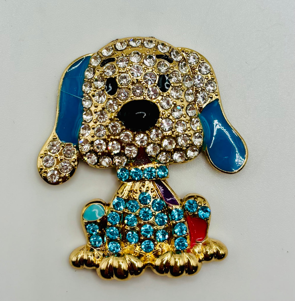 Large blue crystal dog needle minder on white background