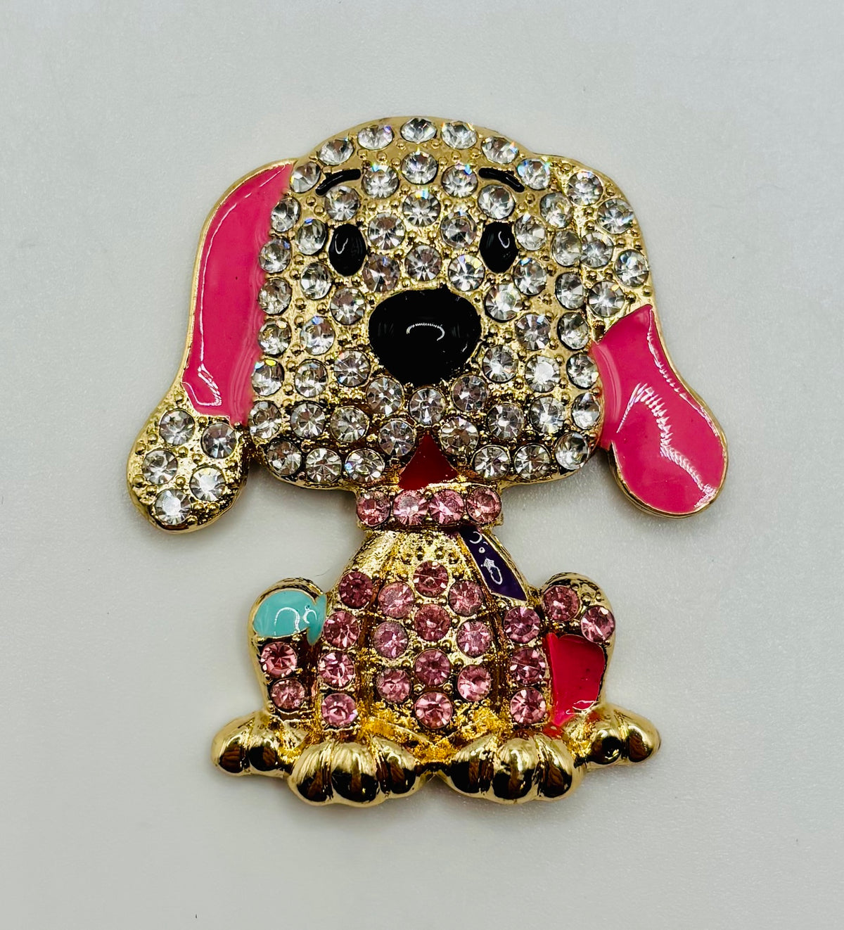 Large pink crystal dog needle minder on white background
