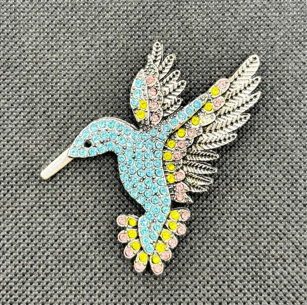Light blue crystal hummingbird needle minder — dark fabric