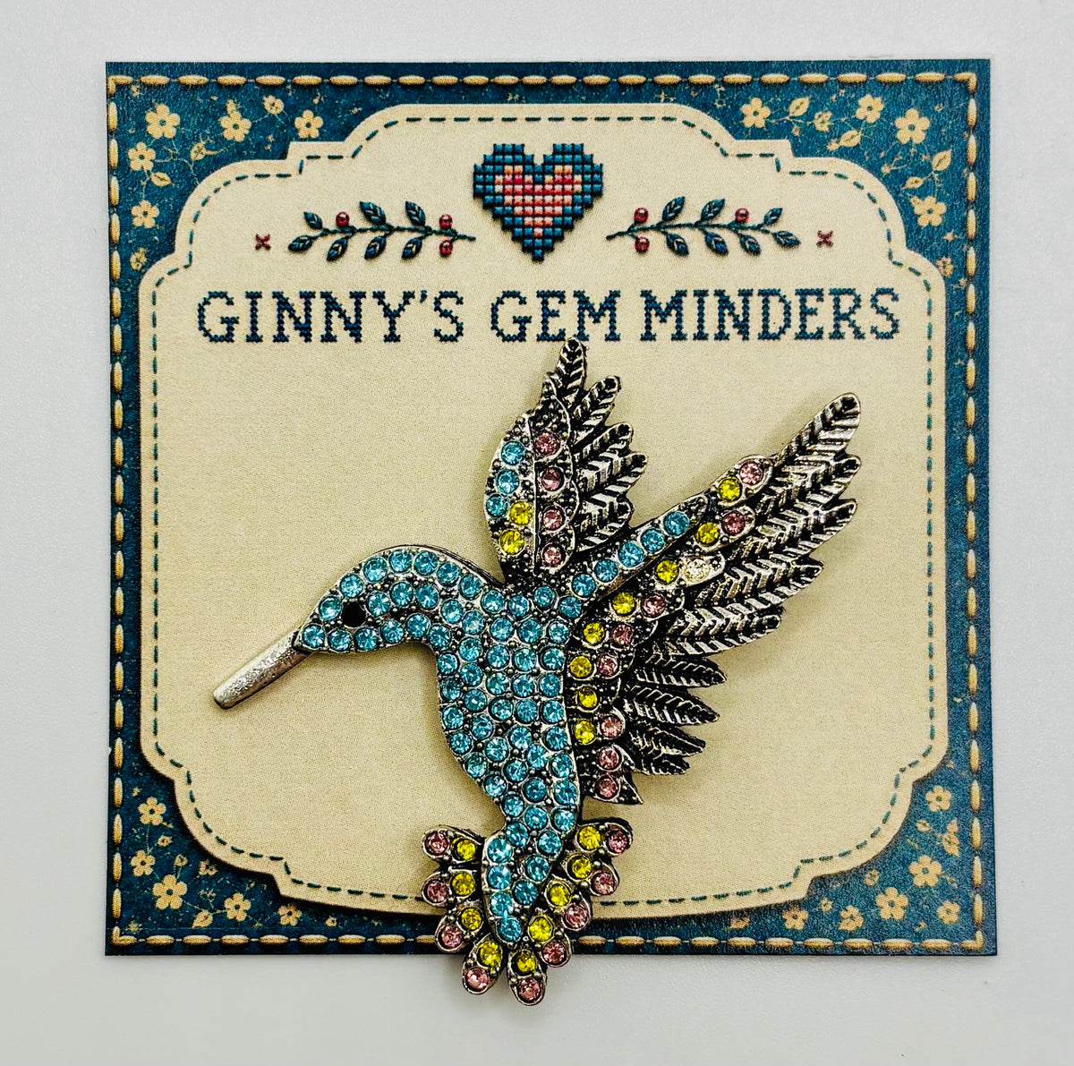 Light blue crystal hummingbird needle minder — display card