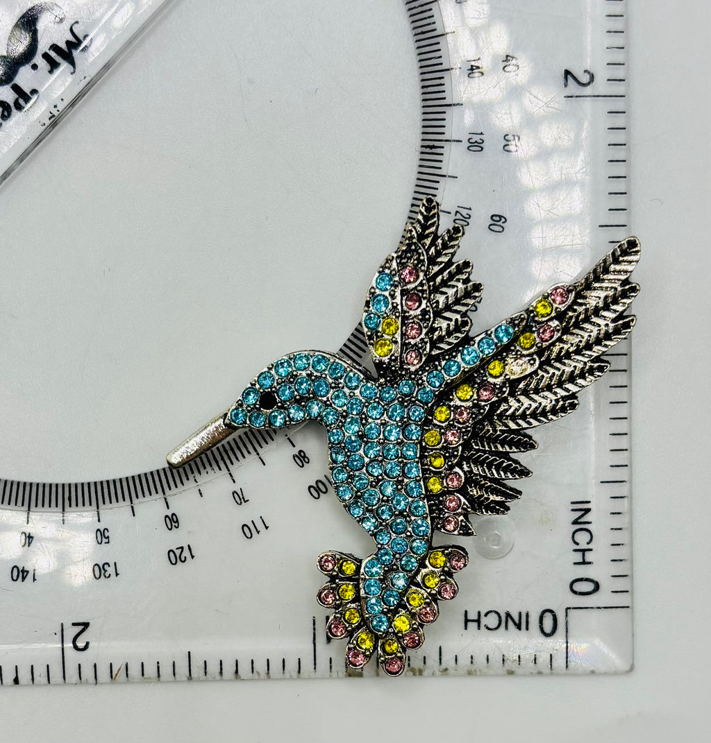 Light blue crystal hummingbird needle minder — ruler scale