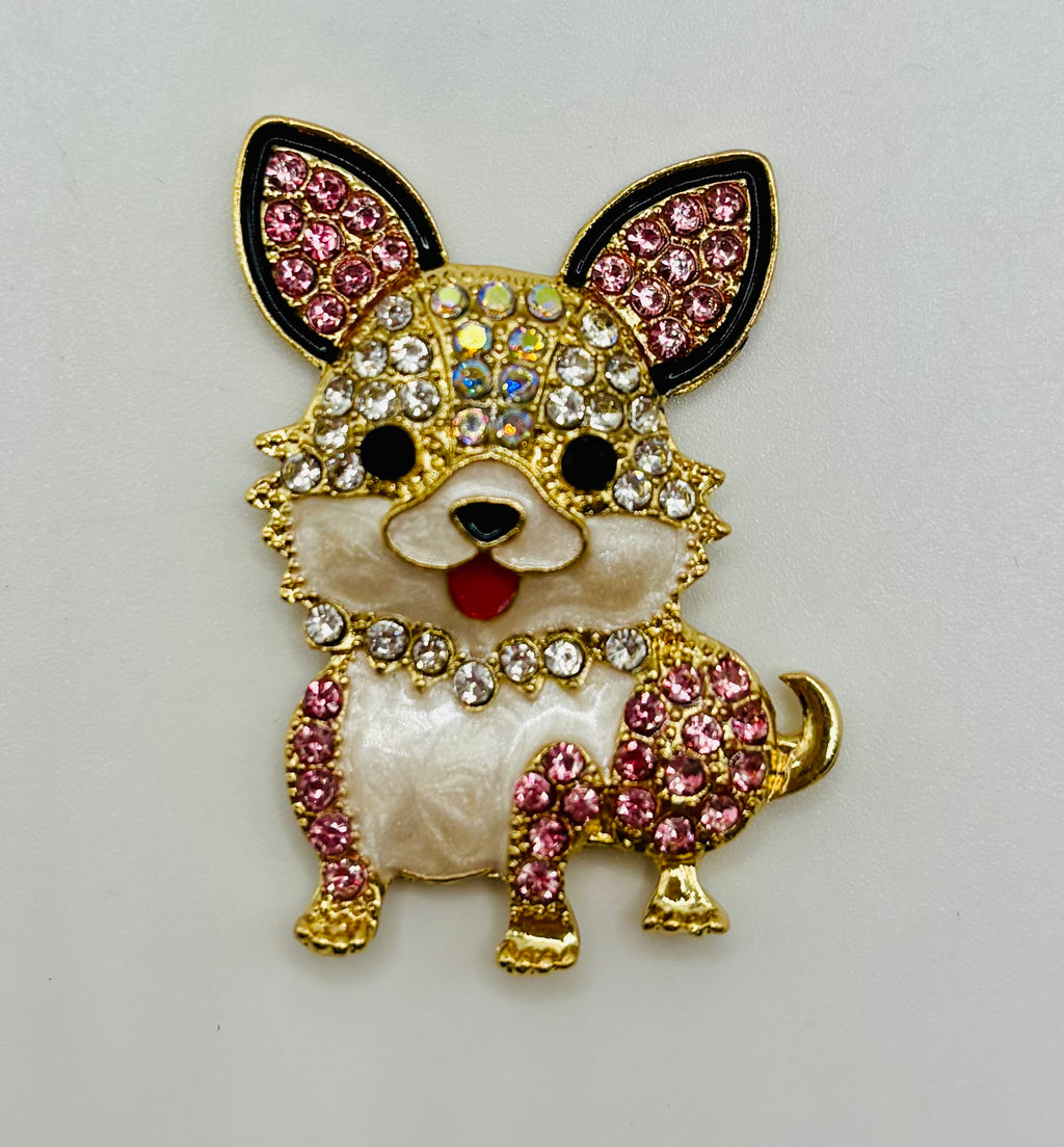 Little pink and clear crystal dog needle minder on white background