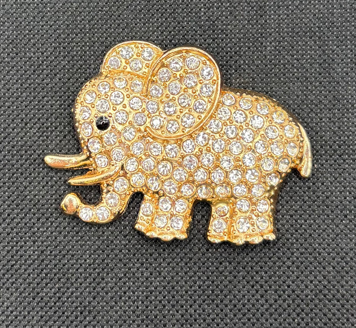 Crystal elephant needle minder on dark fabric