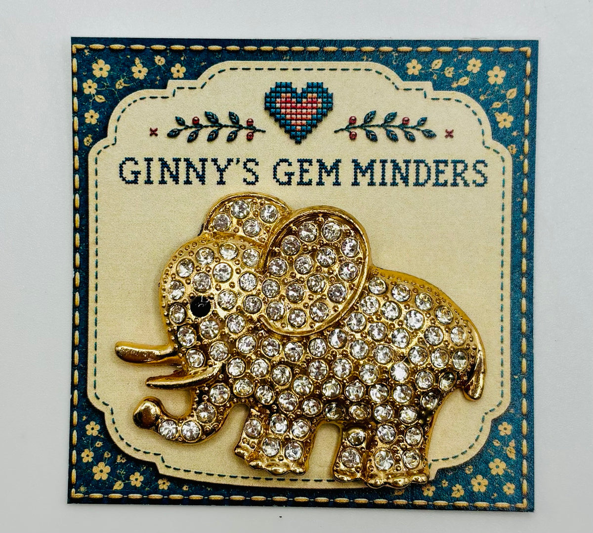 Crystal elephant needle minder on display card