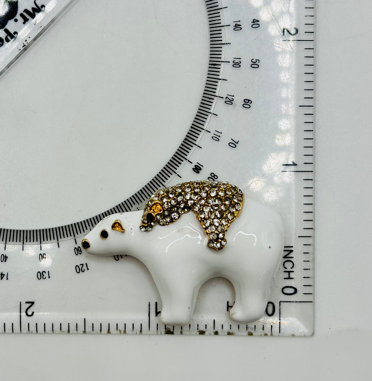 Momma and baby polar bear needle minder beside ruler for scale