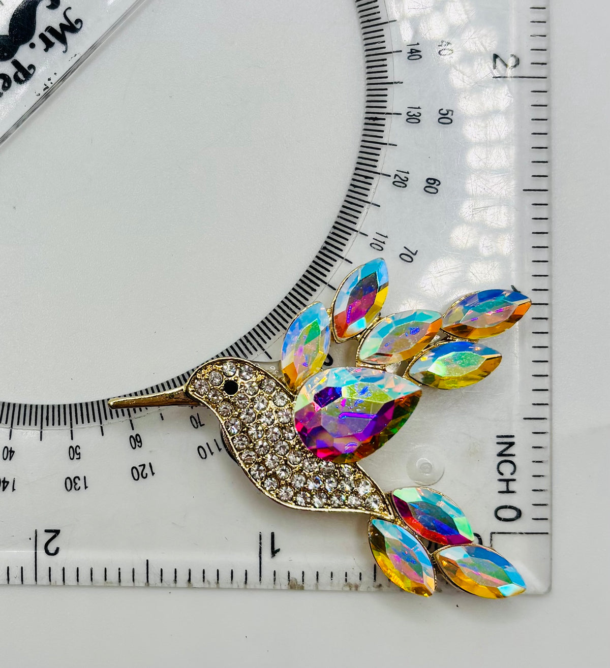 Opalescent crystal hummingbird needle minder — ruler scale