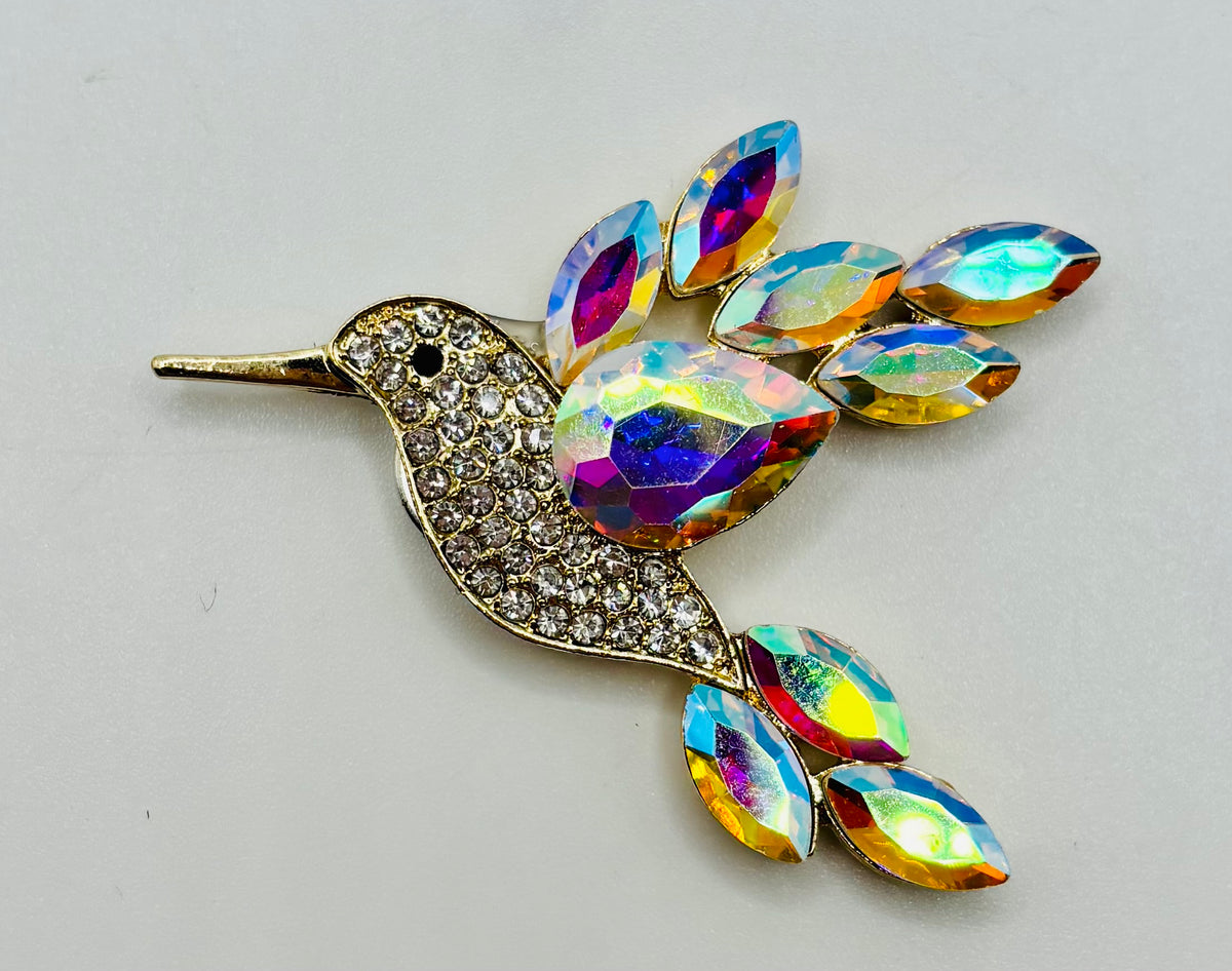 Opalescent crystal hummingbird needle minder — white background