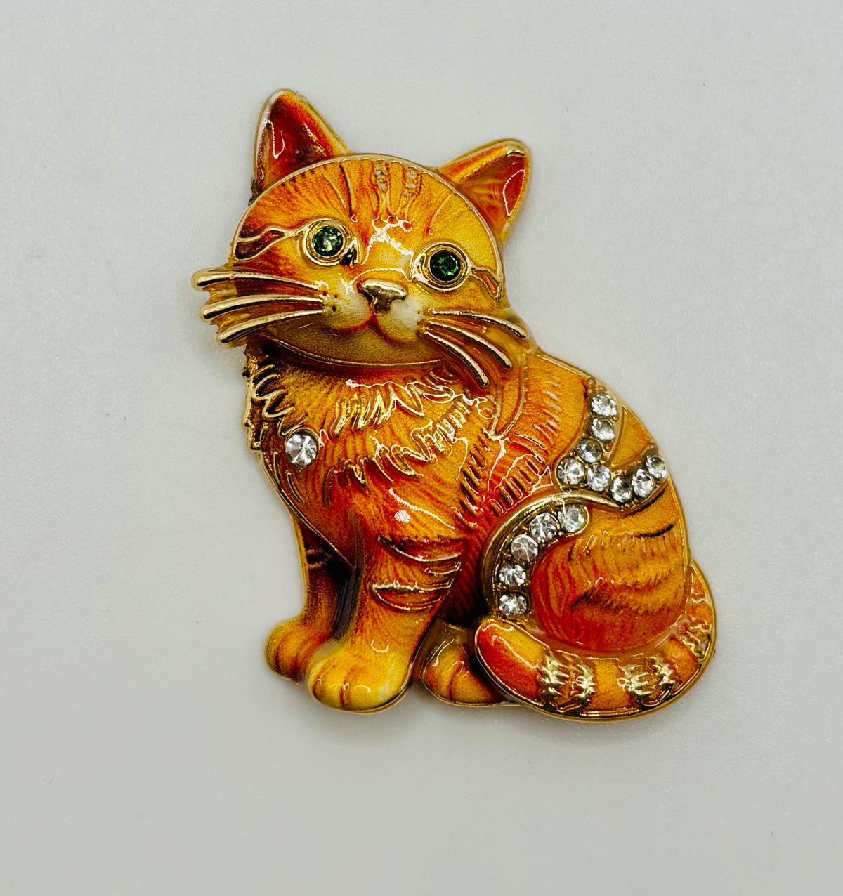 Orange tabby cat kitty needle minder on white background