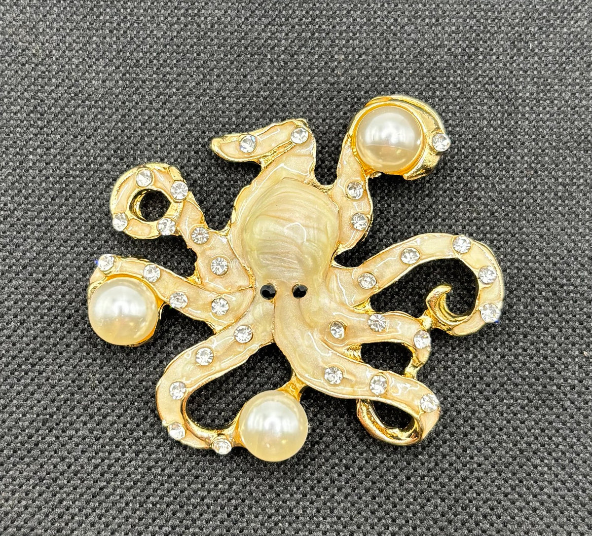 Stunning Pearl Octopus Needle Minder on dark fabric