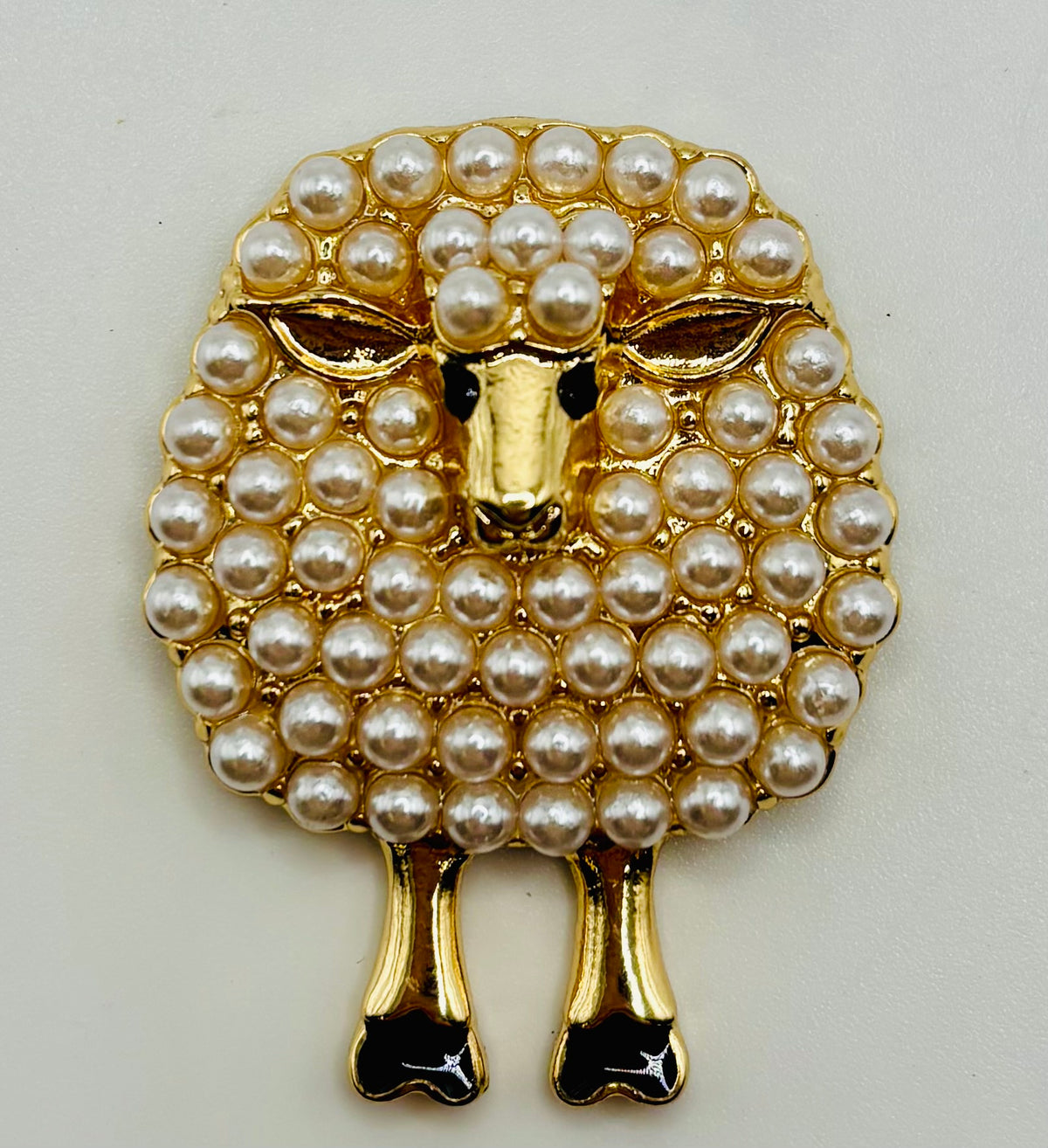 Pearl sheep needle minder on white background