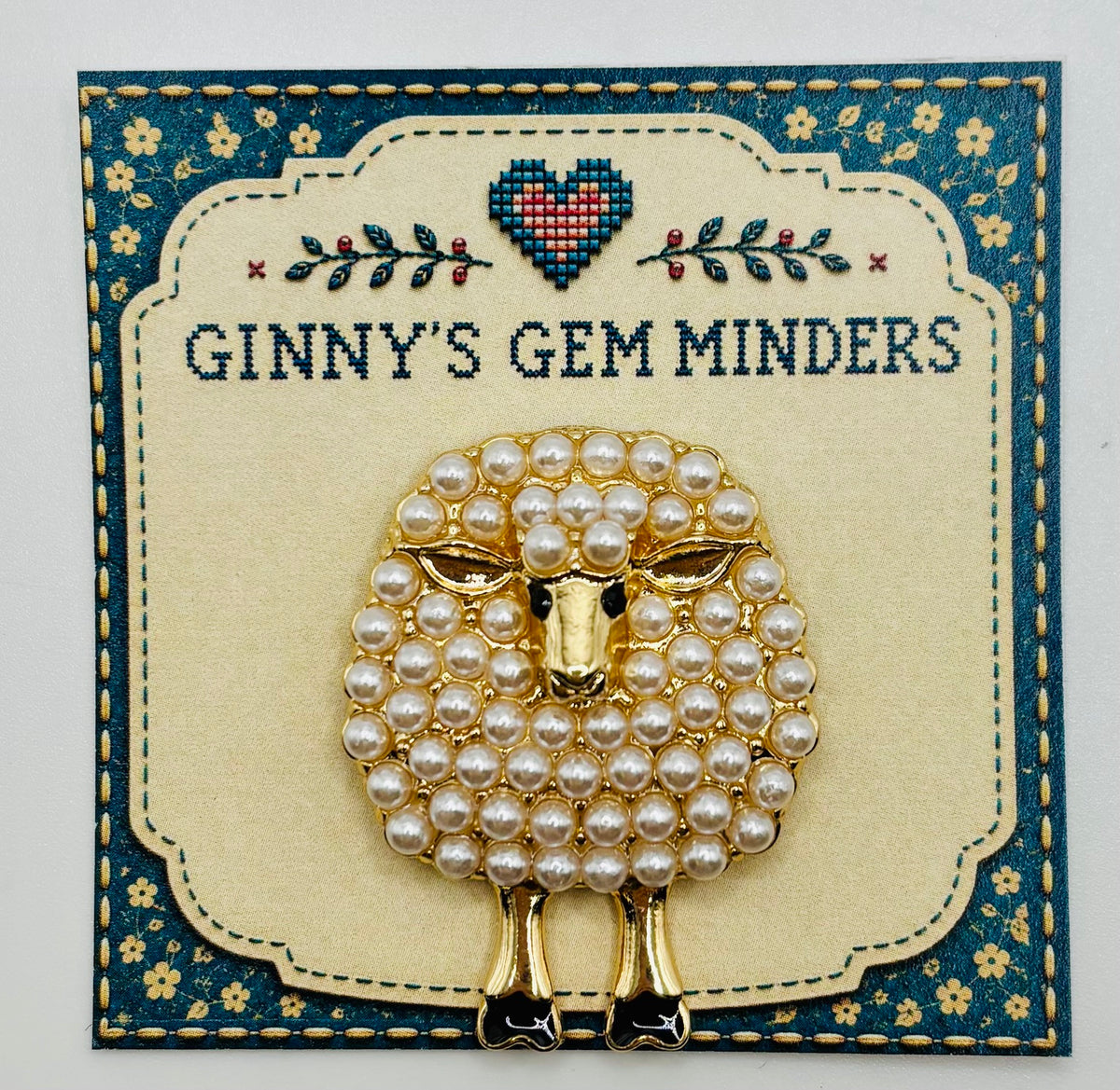 Pearl sheep needle minder on display card