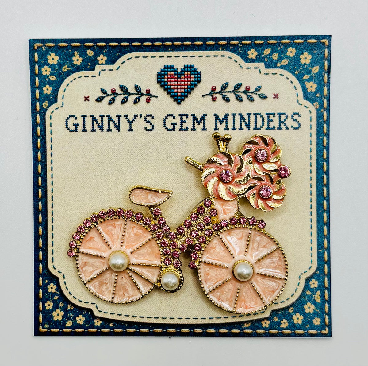 Very Pretty Pink Enamel Bicycle Needle Minder — display card