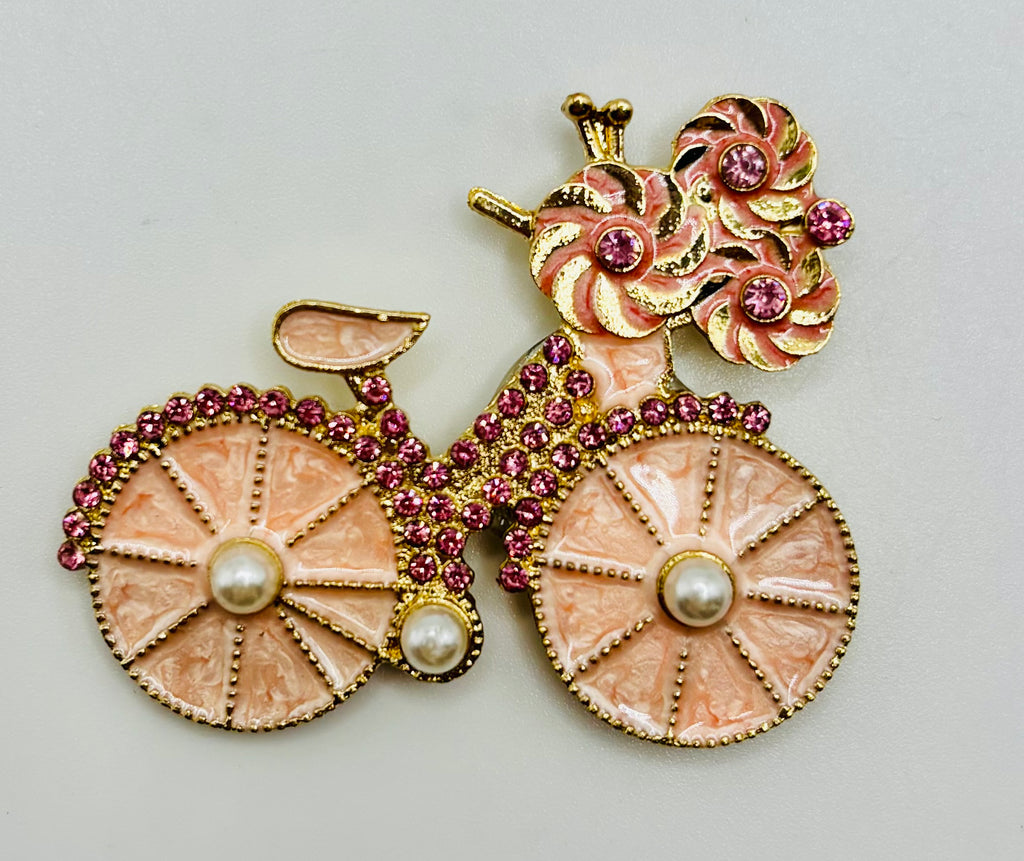 Very Pretty Pink Enamel Bicycle Needle Minder — white background