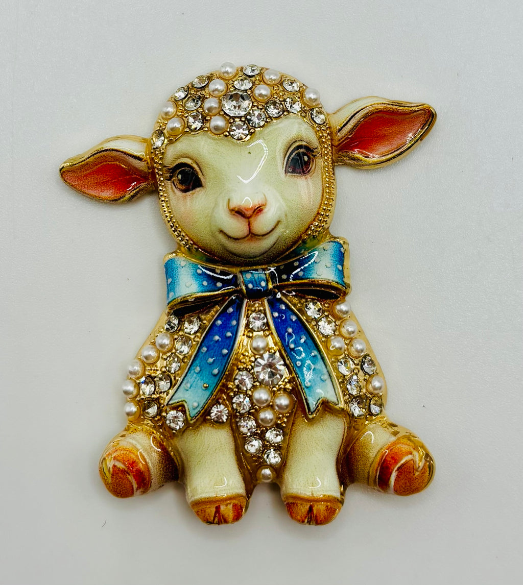 Blue bow lamb needle minder on white background