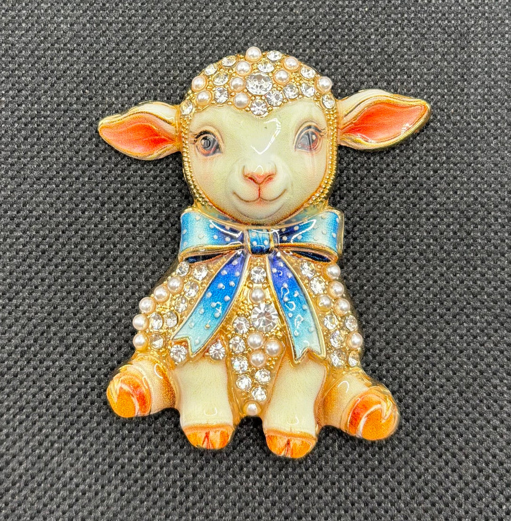 Blue bow lamb needle minder on dark fabric