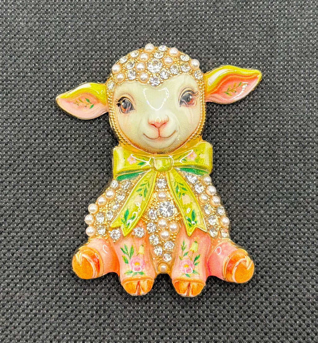 Pink lamb green bow needle minder on dark fabric