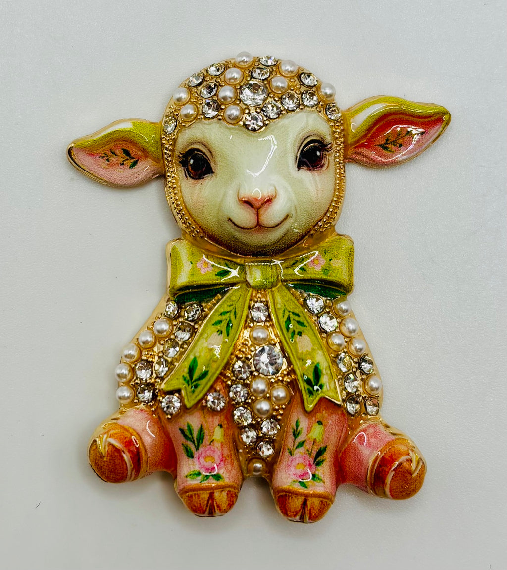 Pink lamb green bow needle minder on white background