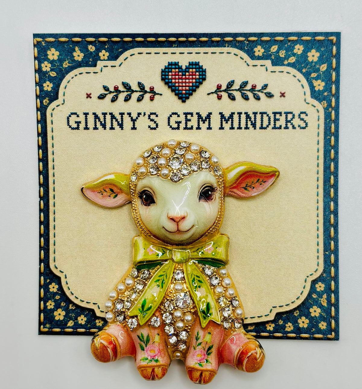 Pink lamb green bow needle minder on display card