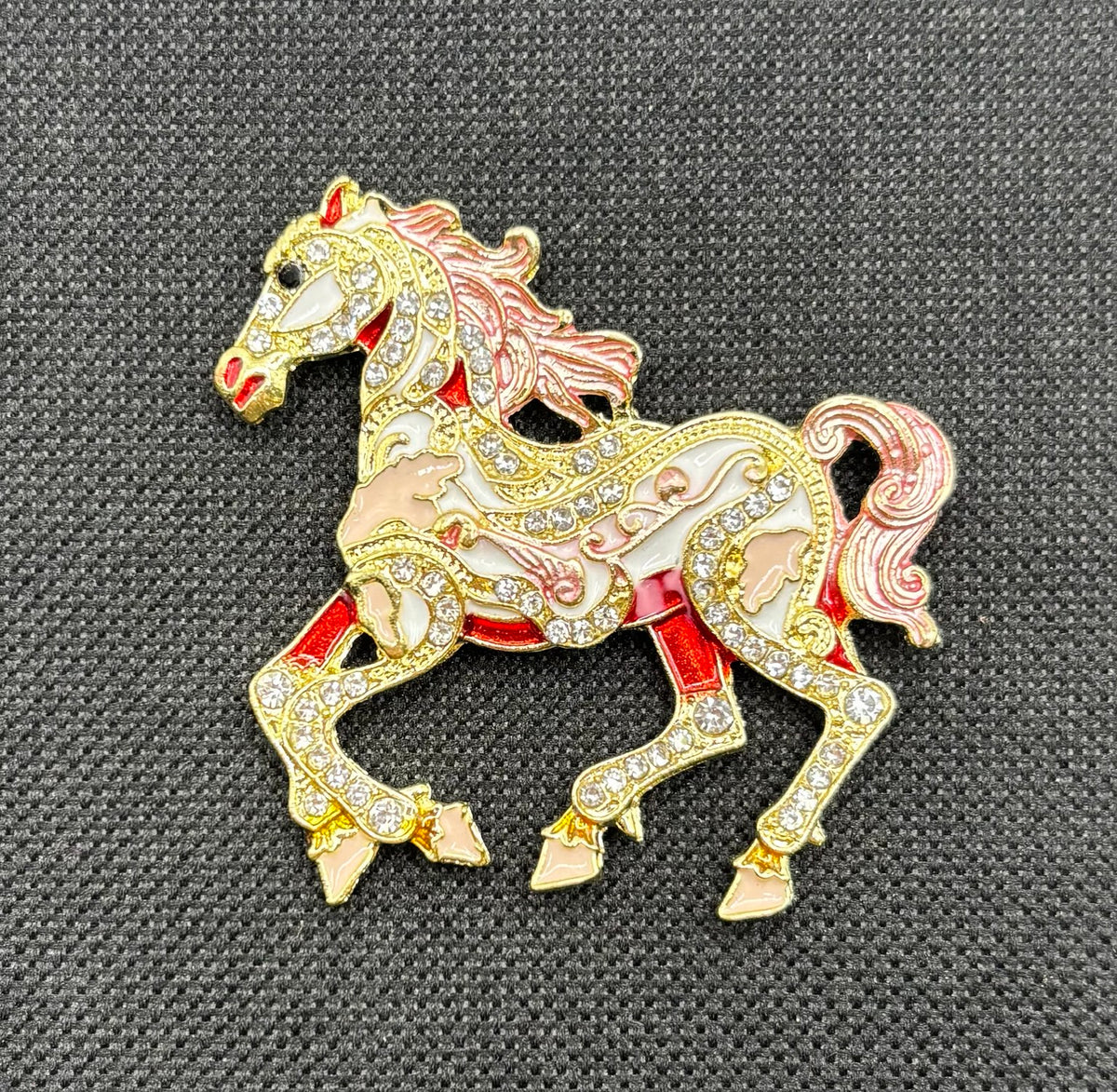 Pink scroll horse needle minder on dark fabric