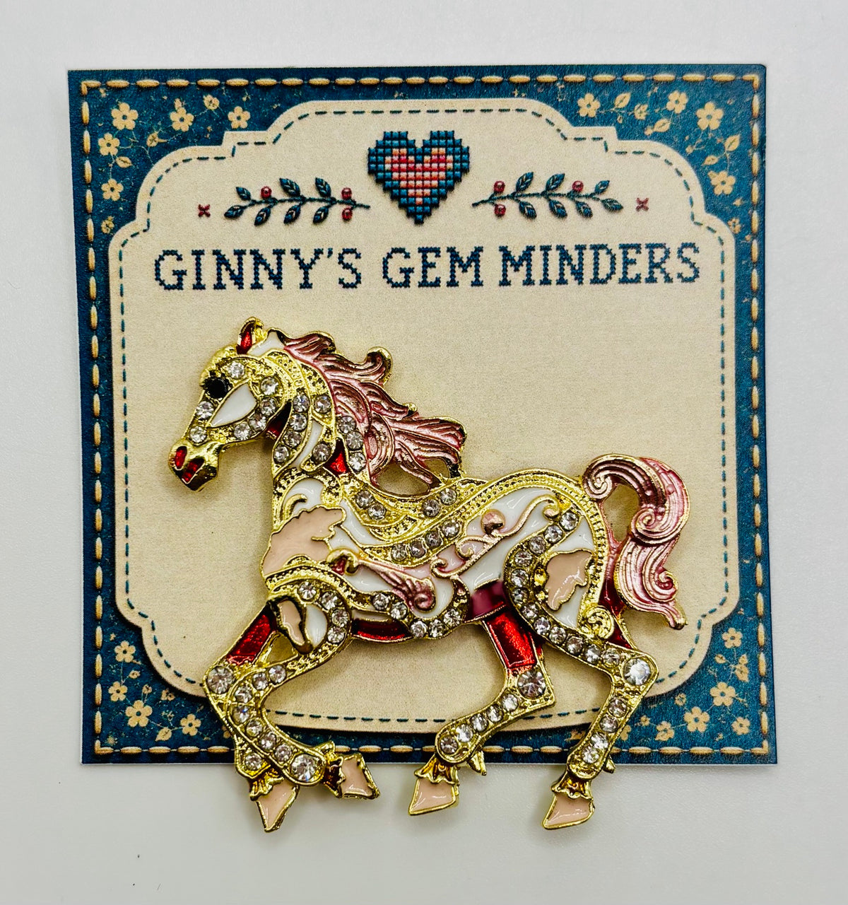 Pink scroll horse needle minder on display card