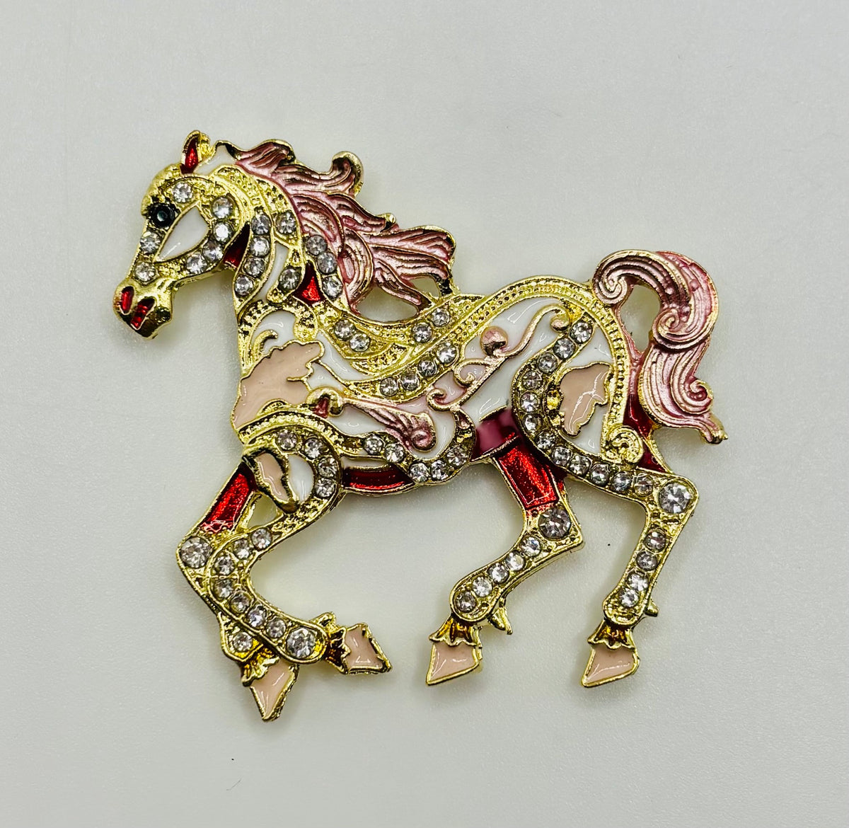 Pink scroll horse needle minder on white background
