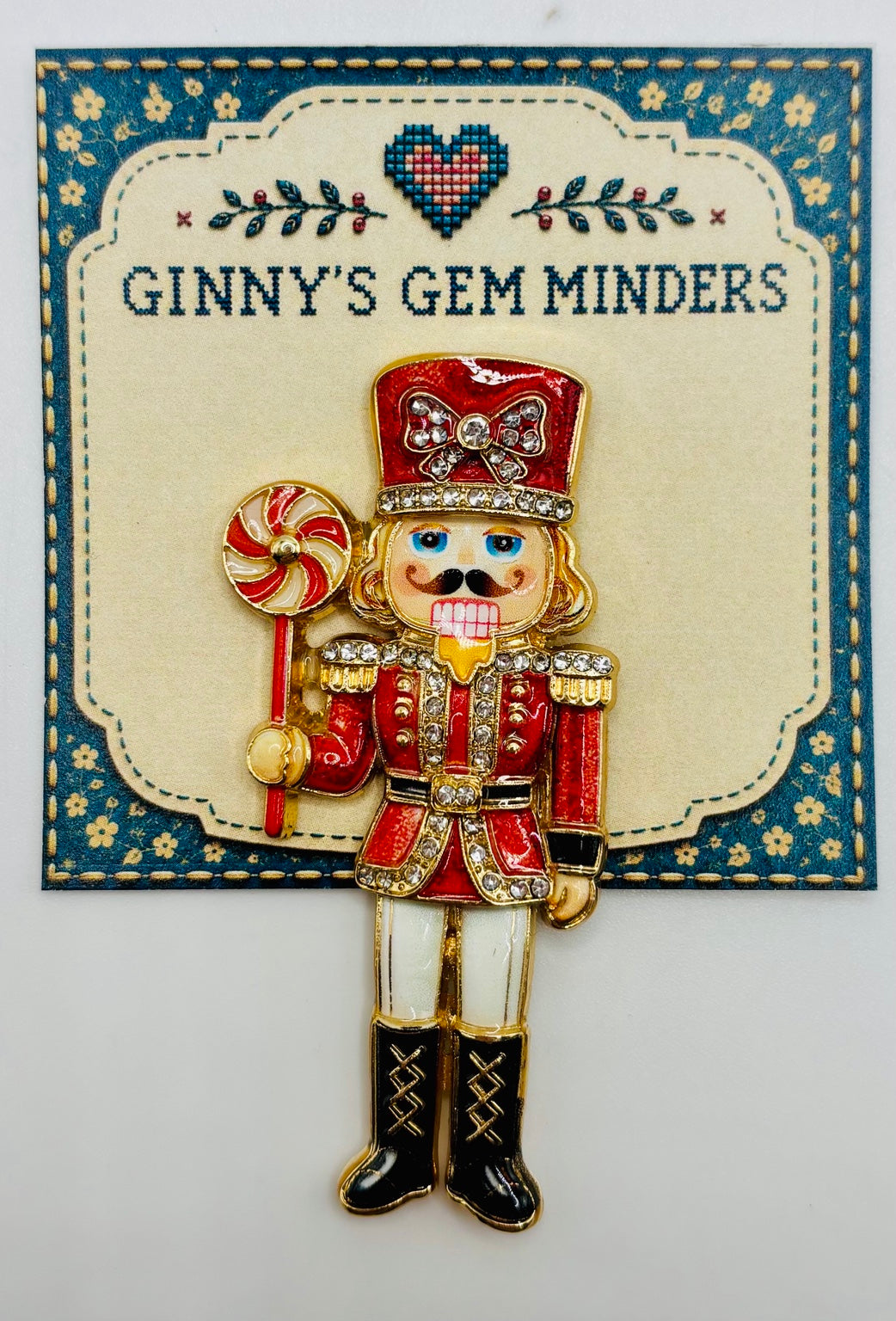 Beautiful Enamel Crystal Red Nutcracker Needle Minder on display card