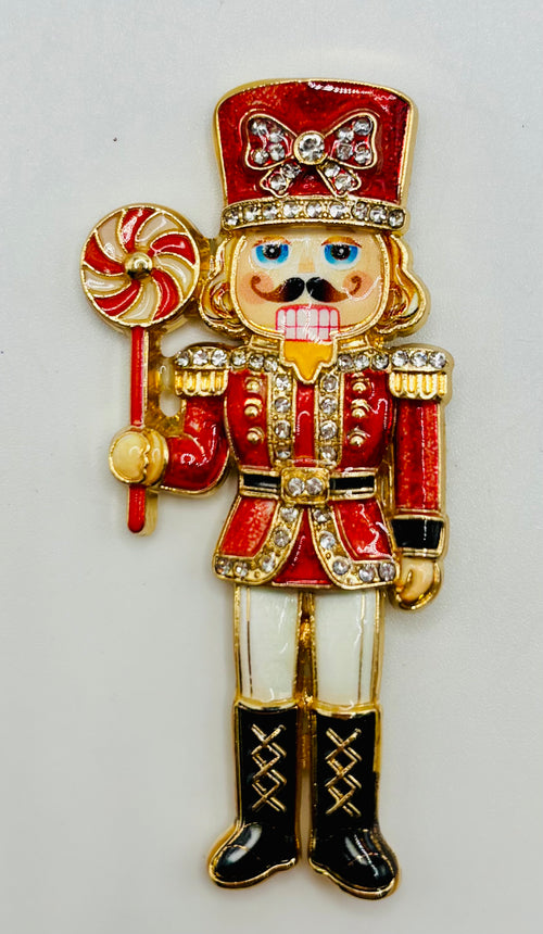 Beautiful Enamel Crystal Red Nutcracker Needle Minder on white background