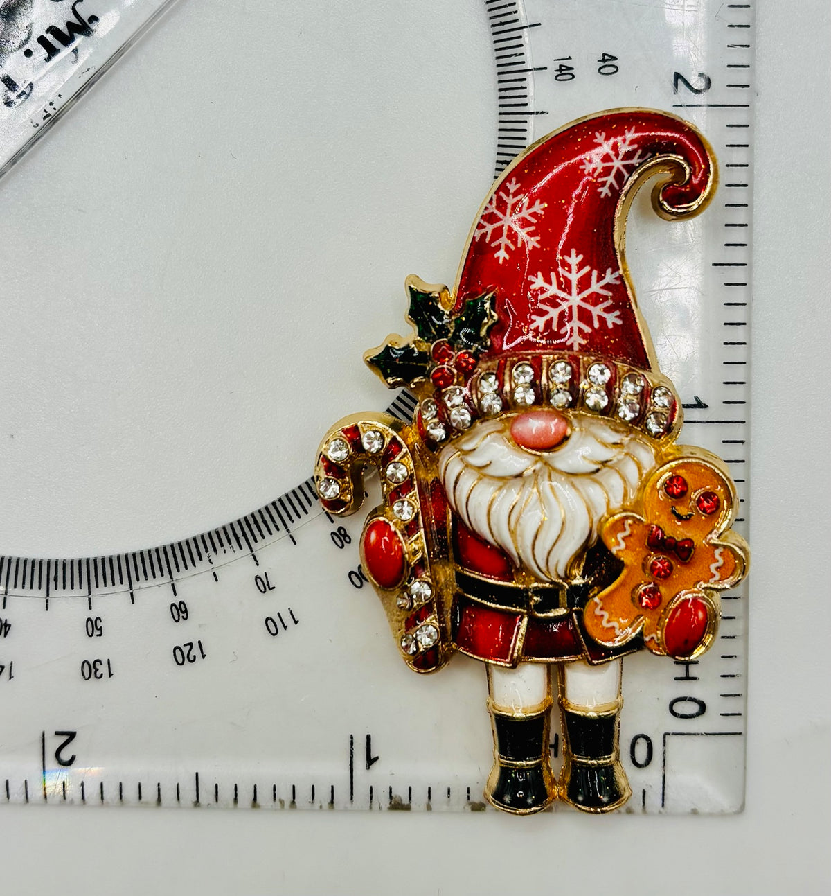 Cute Red Hat Gnome Needle Minder beside a ruler for scale