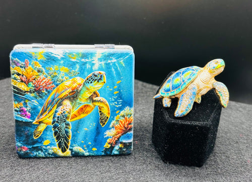 Underwater sea turtle bead case paired with a blue enamel and crystal sea turtle needle minder