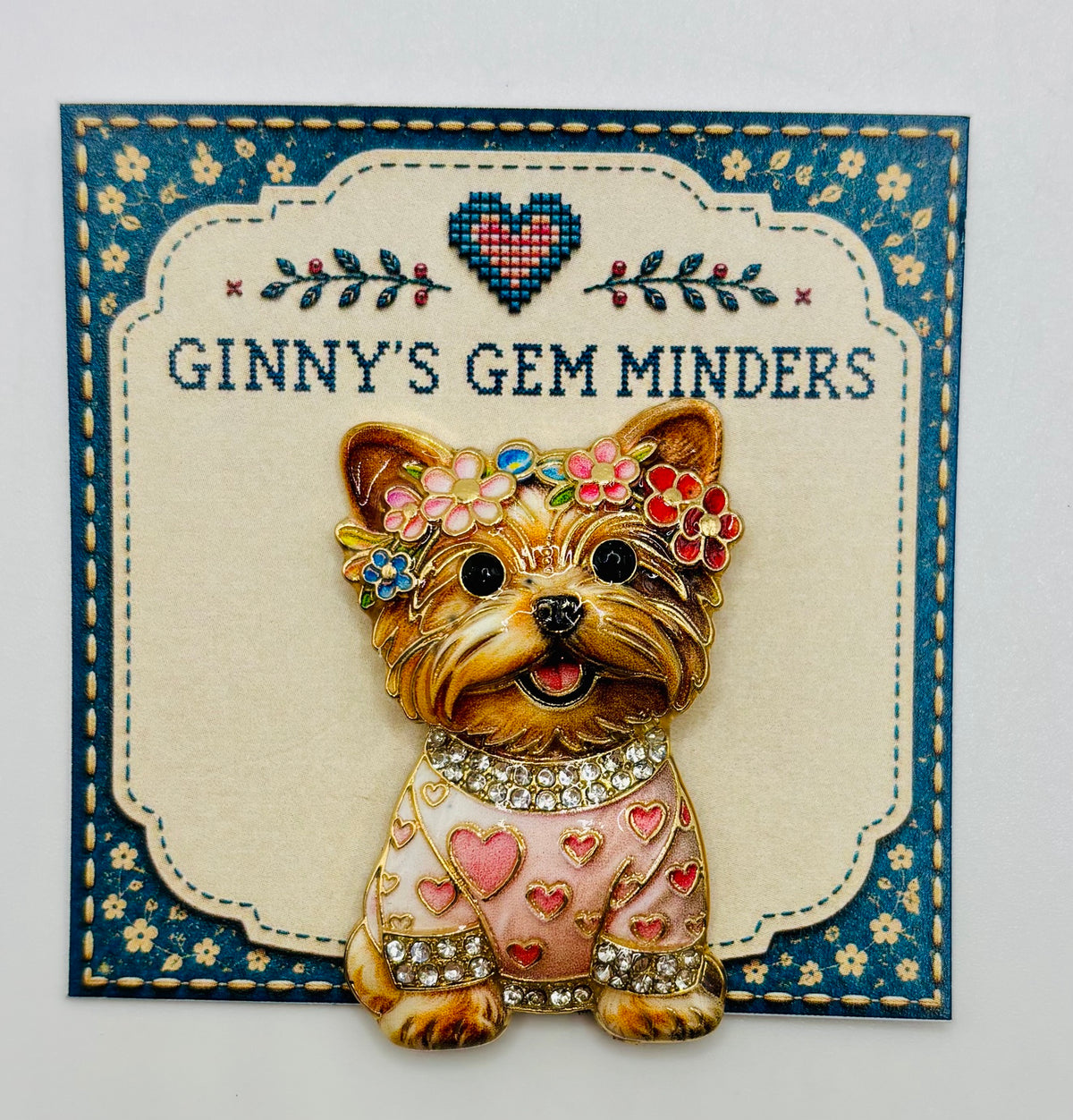 Tan dog in pink heart sweater needle minder on display card