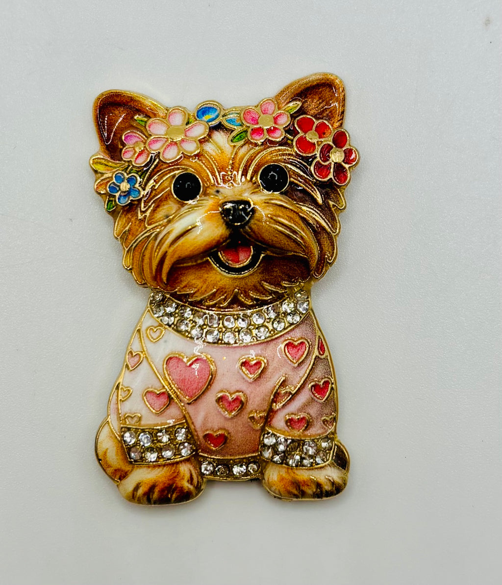 Tan dog in pink heart sweater needle minder on white background